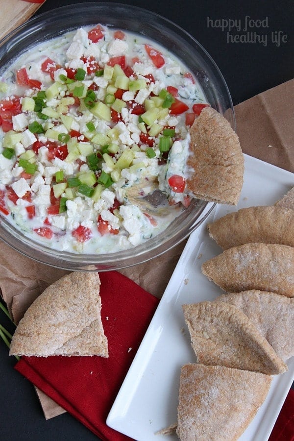 Healthy Greek Layer Dip - the perfect addition to any potluck, BBQ, or get-together this summer. www.happyfoodhealthylife.com