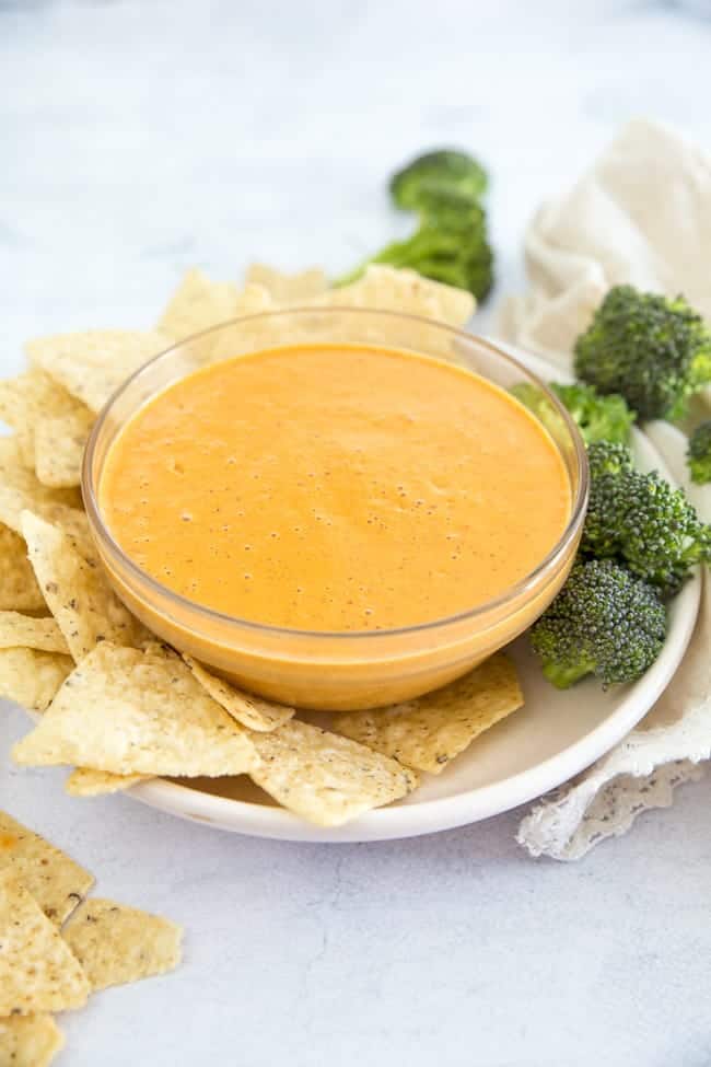 Vegan Cheese that is perfect for a veggie dip, pouring on nachos, smothering your burritos and potatoes with. An easy dairy free recipe that comes together in no-time.