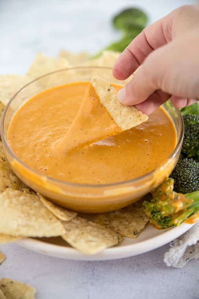 Vegan Cheese that is perfect for a veggie dip, pouring on nachos, smothering your burritos and potatoes with. An easy dairy free recipe that comes together in no-time.