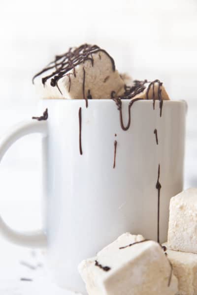 mug of marshmallows drizzled with chocolate.