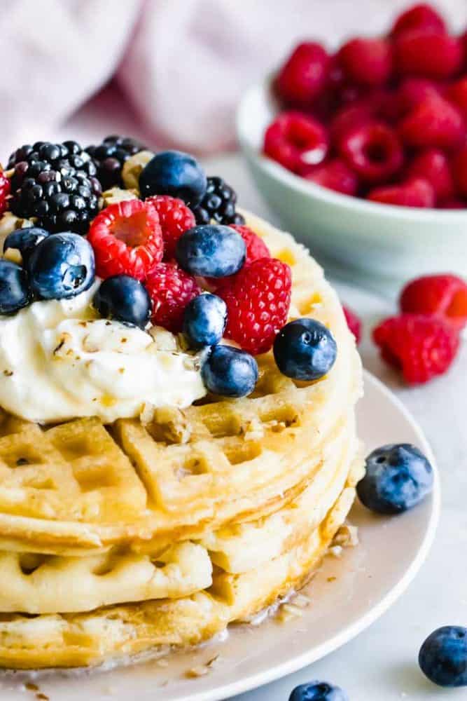 vegan waffle recipe piled high with berries