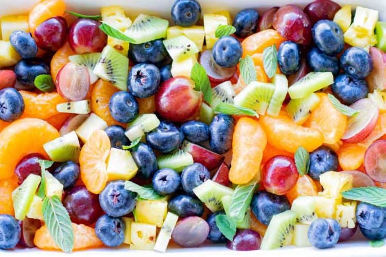 white rectangle dish of summer fruit salad. 