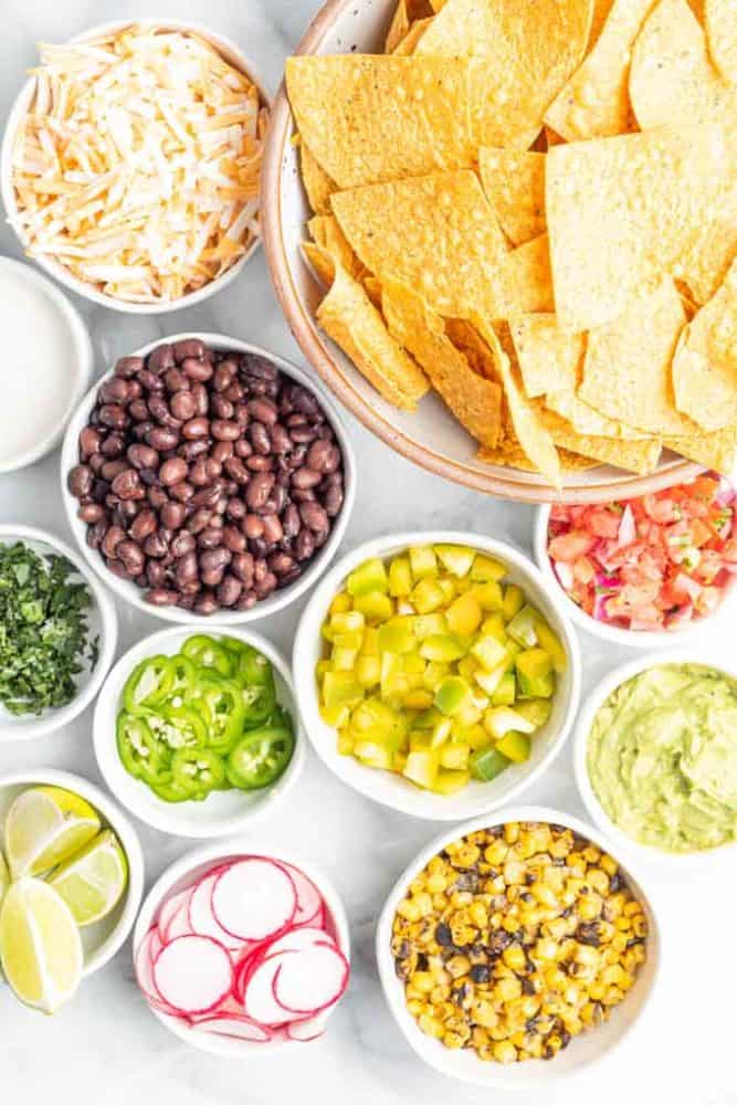 ingredients needed for vegan nachos in separate dishes.