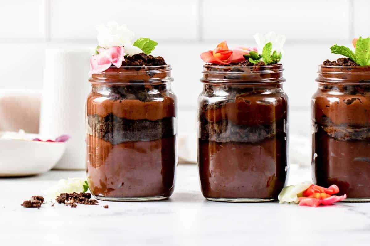 a row of dirt cups in a jar