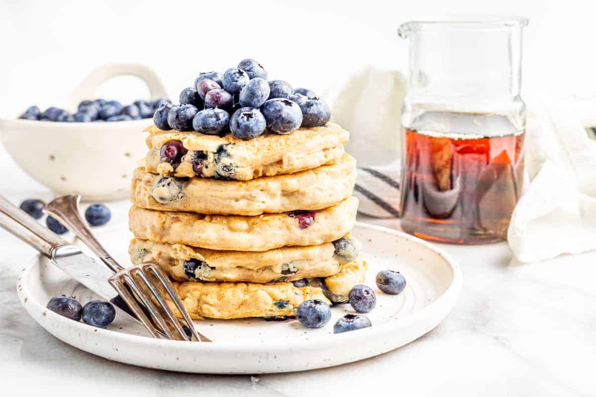 vegan blueberry pancakes - stacked up tall and ready to bite into