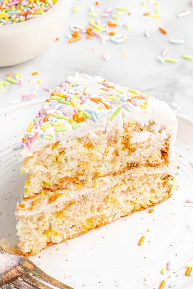 Slice of frosted vegan birthday cake