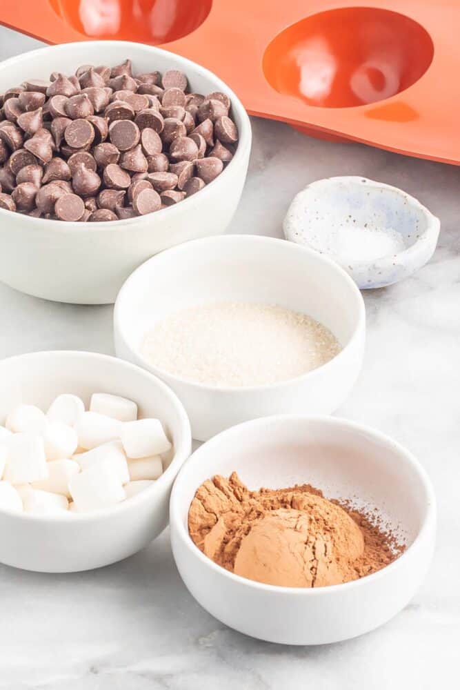 ingredients needed for vegan hot chocolate bombs in individual white bowls