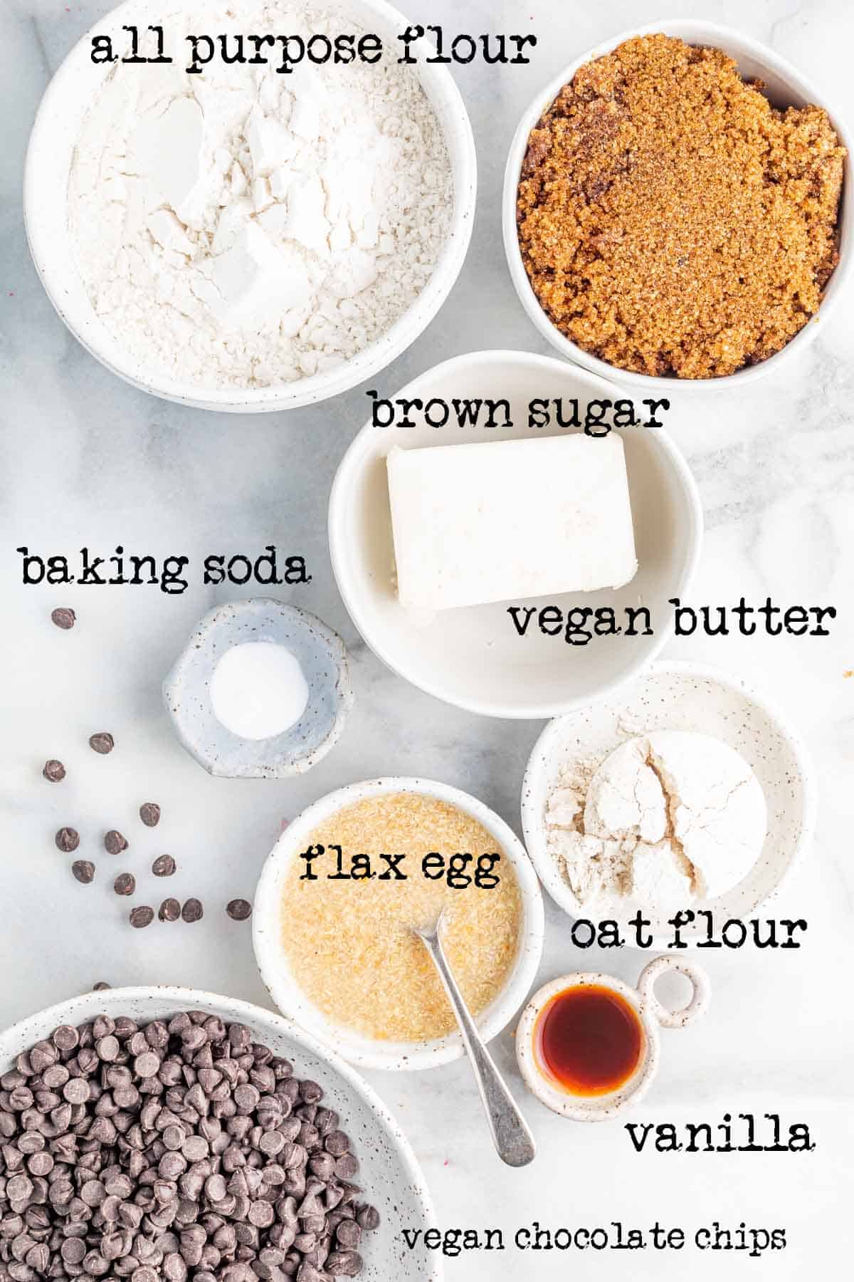 an overhead image of all ingredients needed to make plant based chocolate chip cookies with labels on the ingredients.