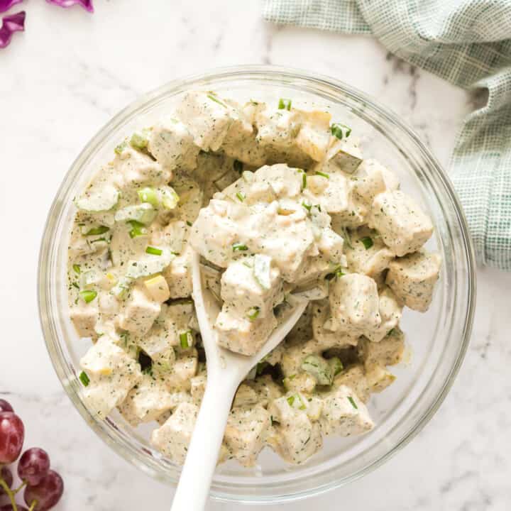 a clear bowl filled with vegan chicken salad sandwich mix