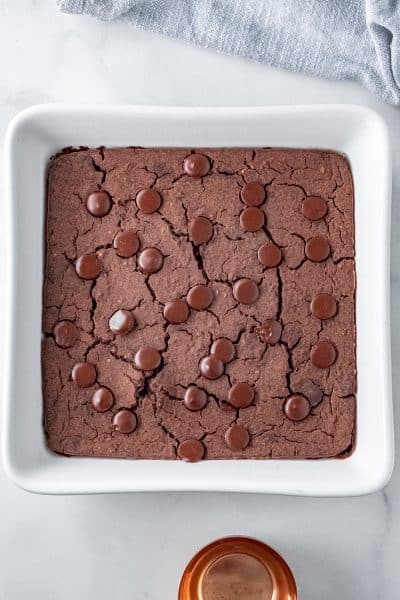 Top view photo of black bean brownies, fully cooked in a white baking dish, and cooling until ready to enjoy.
