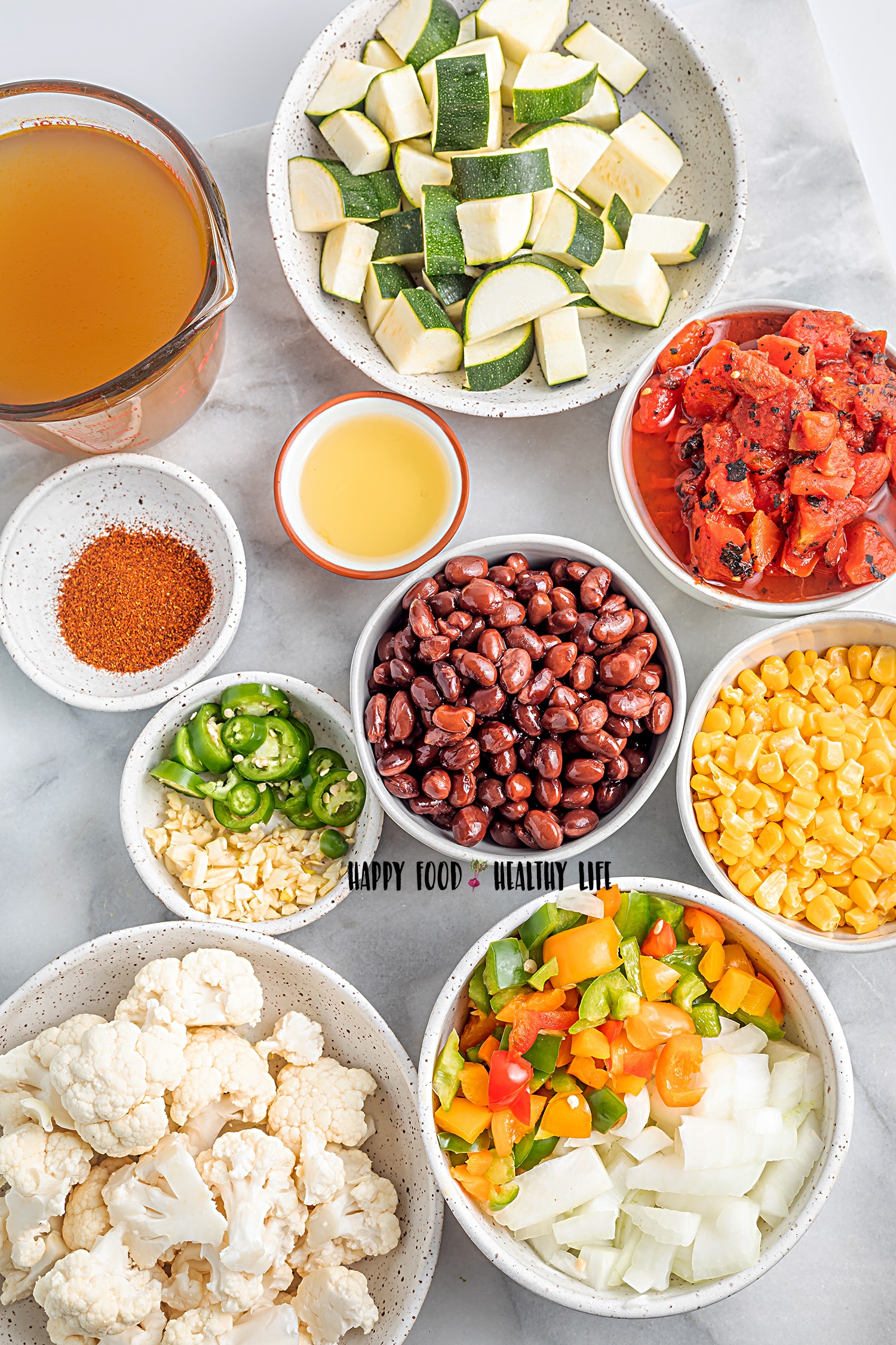Top view photo of all the ingredients to make Vegan Tortilla Soup in separate bowls.