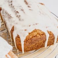 Photo of a completely cooled Vegan Pumpkin Bread loaf that has been glazed with a maple icing. It is ready to enjoy!