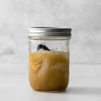 Photo of the hemlock drink, in a mason jar, ready to be shaken until ready to serve.
