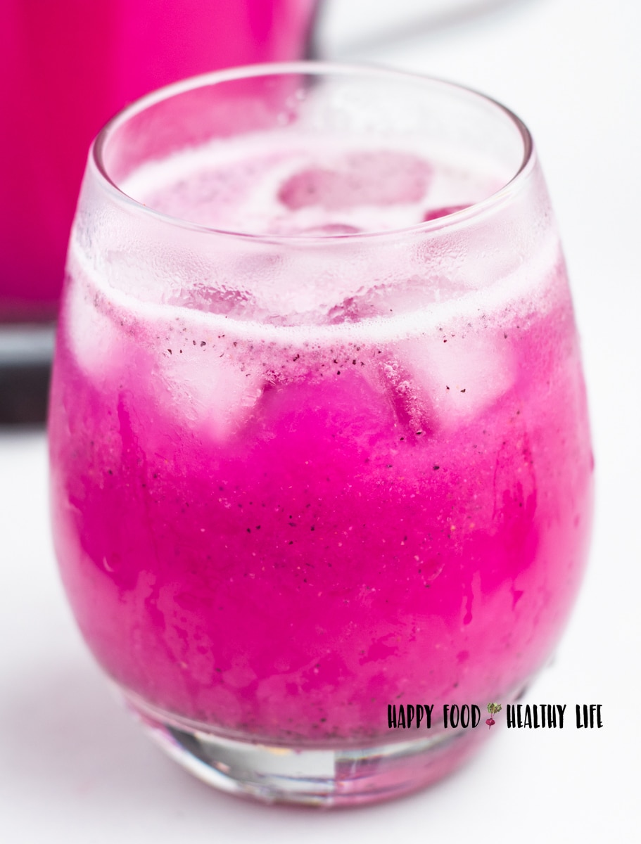 Closeup photo of a small glass of Dragon Fruit Lemonade with ice.